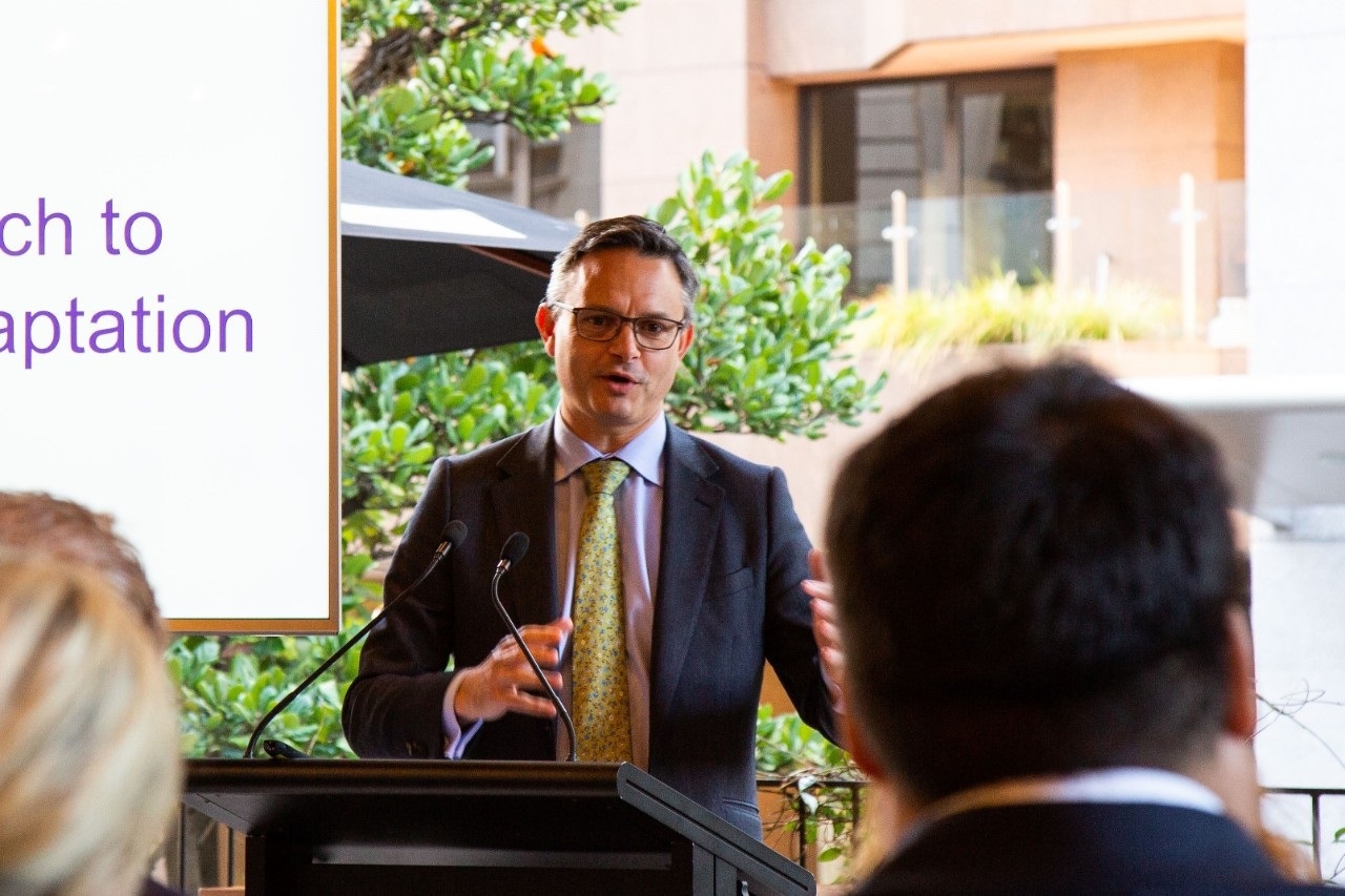 Presenter at lectern presenting in an outdoor setting